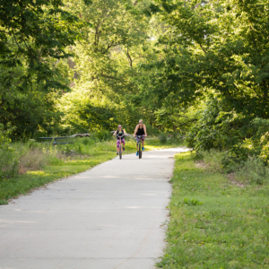 Parent and child riding bikes along the Cowboy Trail