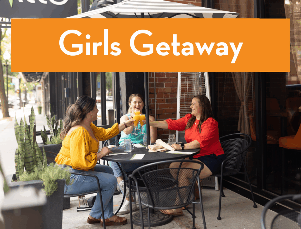 Image of girls cheersing on a patio in the Downtown Norfolk River Point District